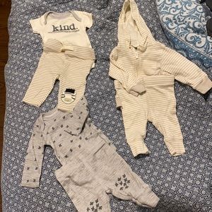 Three whole neutral newborn outfits